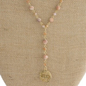 Gold tone layered necklace with natural stone and boho charm.