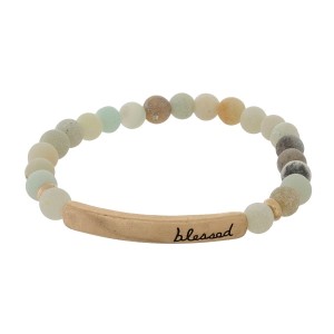 Beaded stretch bracelet with a bar focal, stamped with "blessed."