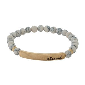 Beaded stretch bracelet with a bar focal, stamped with "blessed."