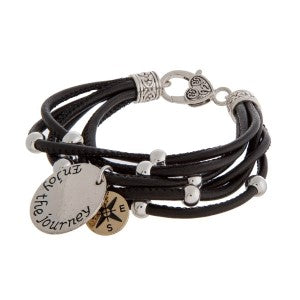 Faux leather bracelet with silver tone beads, a lobster clasp, and a stamped charm.