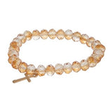 Stretch bracelet with faceted beads and cross charm.