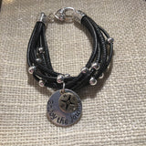 Faux leather bracelet with silver tone beads, a lobster clasp, and a stamped charm.