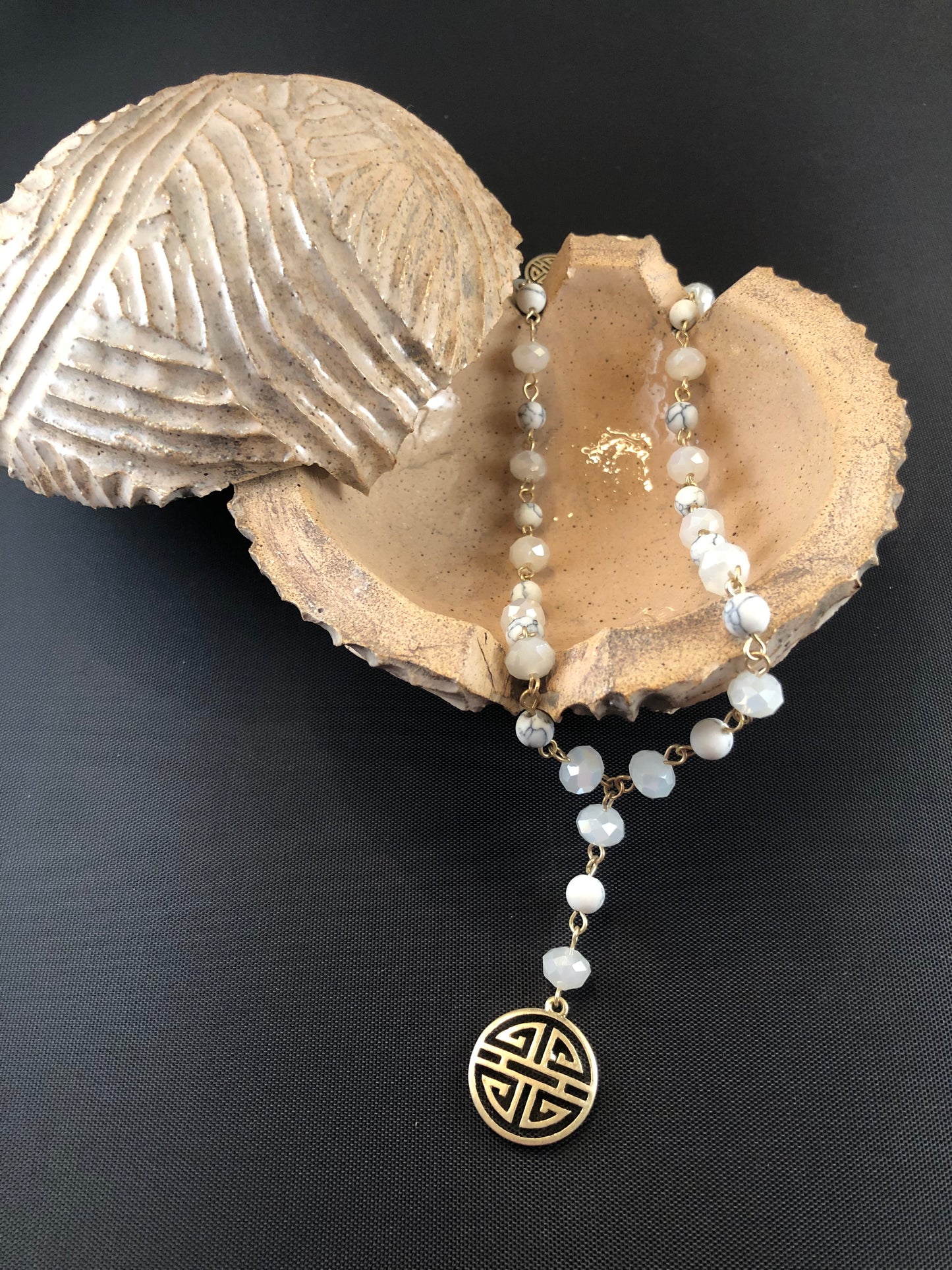 Gold tone, Y necklace with natural stone beads and a boho pendant.