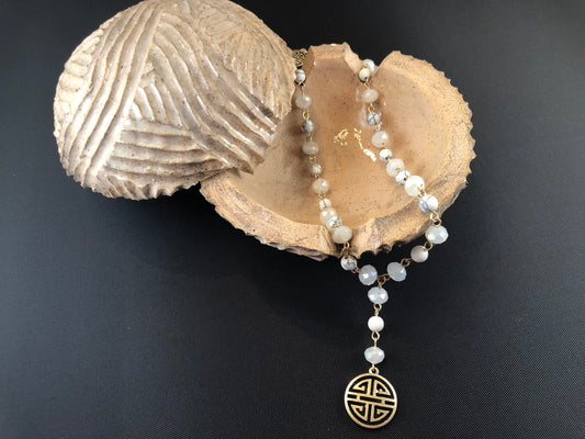 Gold tone, Y necklace with natural stone beads and a boho pendant.