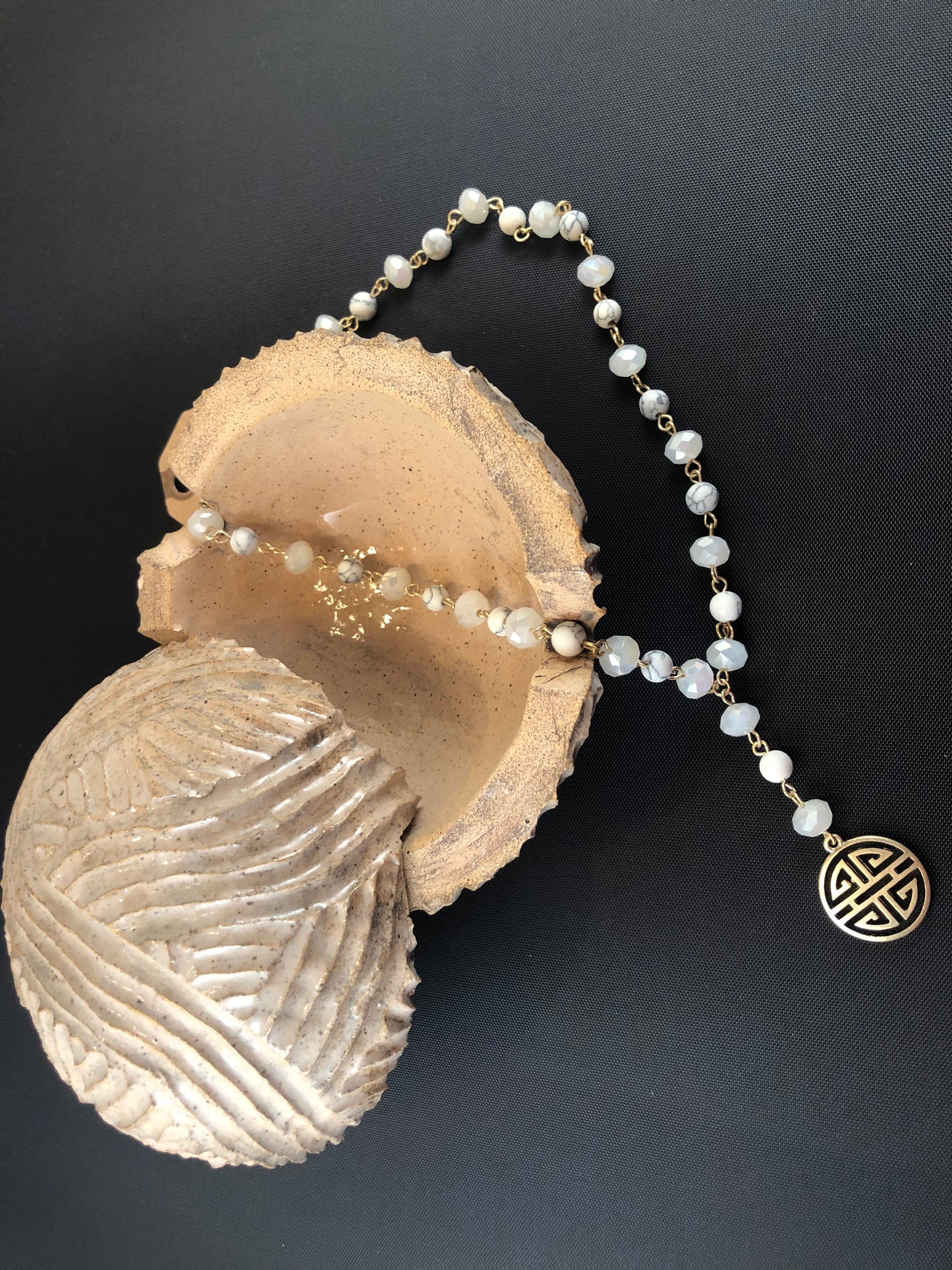 Gold tone, Y necklace with natural stone beads and a boho pendant.