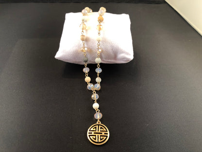 Gold tone, Y necklace with natural stone beads and a boho pendant.