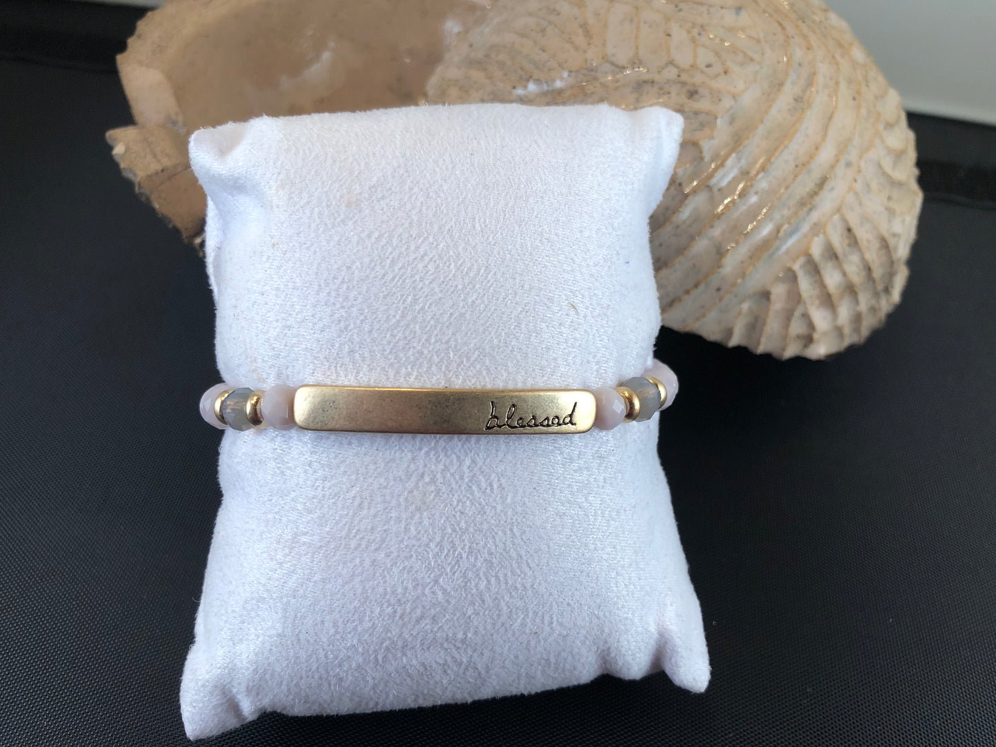 Beaded stretch bracelet with a bar focal, stamped with "blessed."
