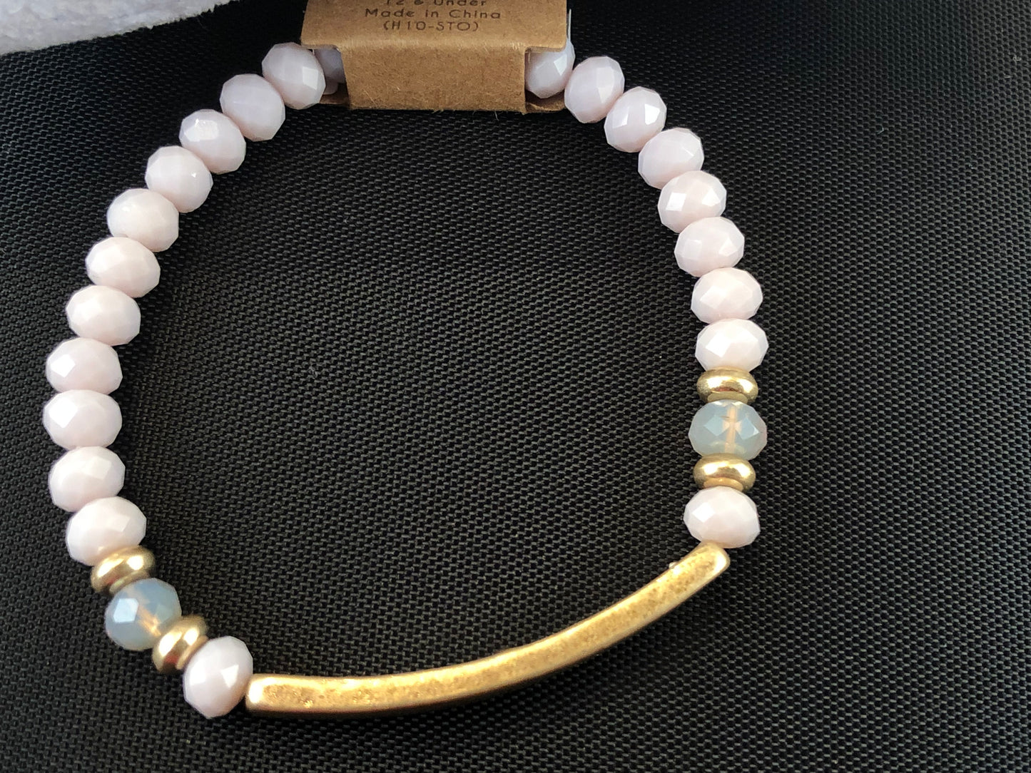 Beaded stretch bracelet with a bar focal, stamped with "blessed."
