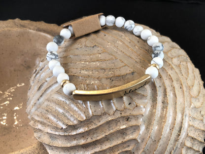Beaded stretch bracelet with a bar focal, stamped with "blessed."