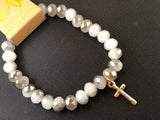 Stretch bracelet with faceted beads and cross charm.