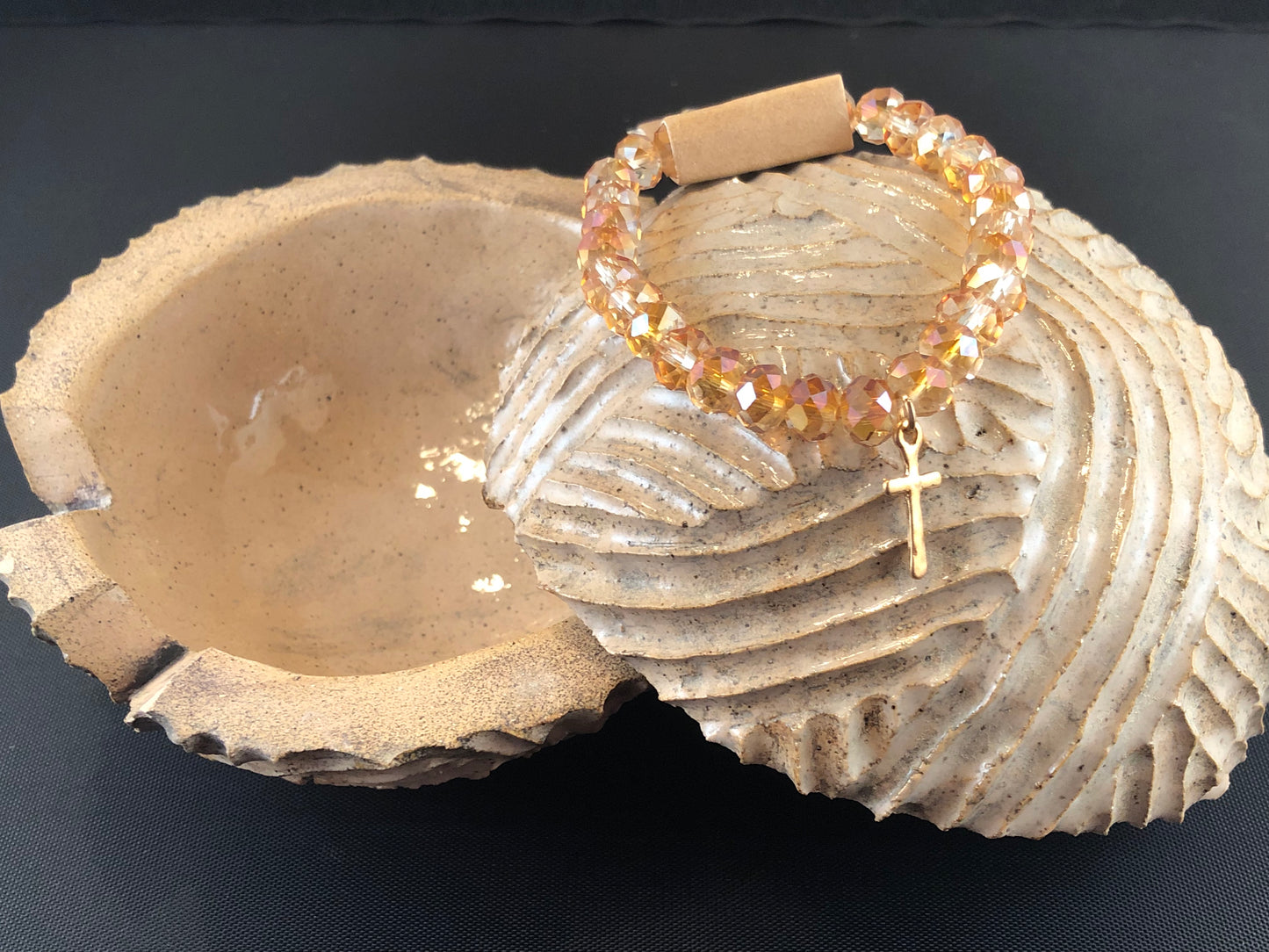 Stretch bracelet with faceted beads and cross charm.