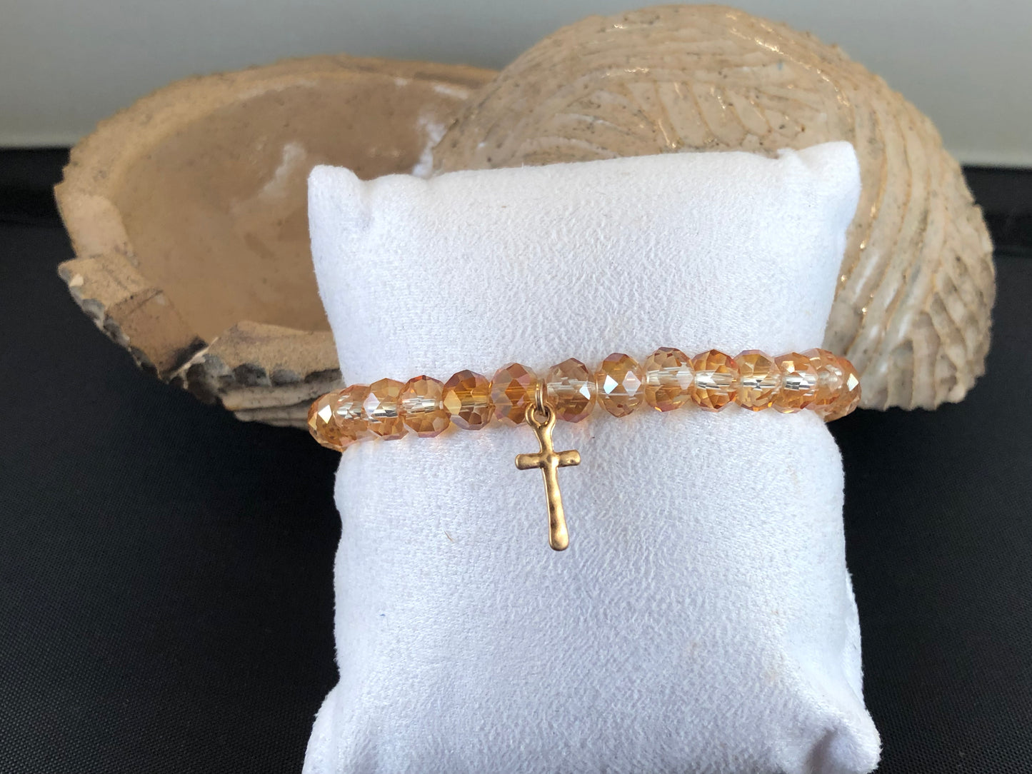 Stretch bracelet with faceted beads and cross charm.