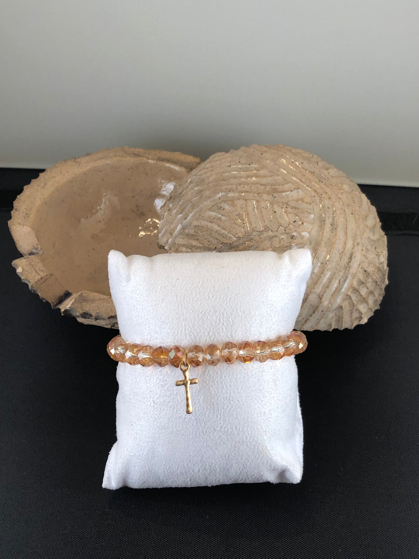 Stretch bracelet with faceted beads and cross charm.