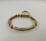 Beaded stretch bracelet with a bar focal, stamped with "amazing grace."